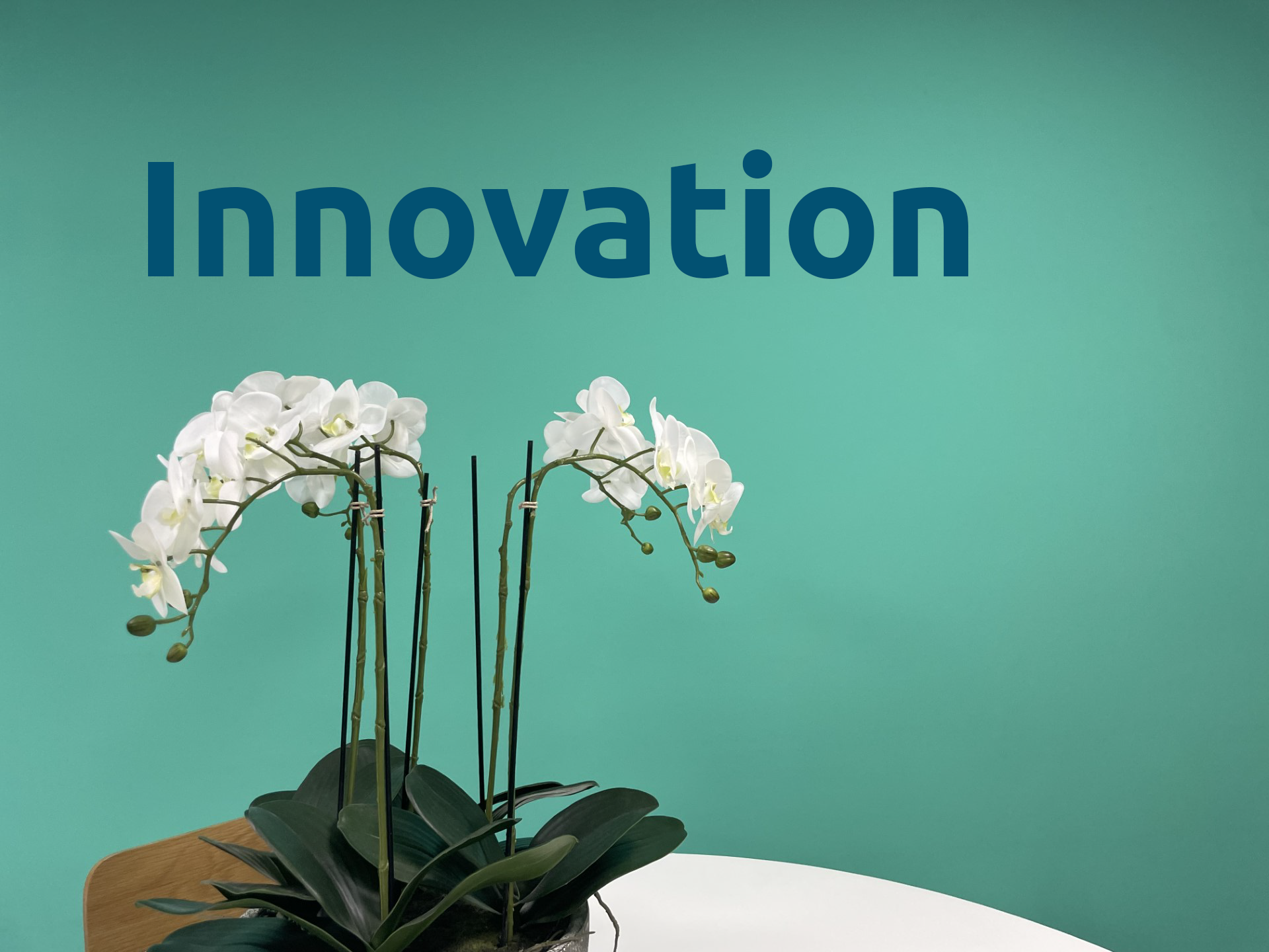 green mural that says 'innovation' on our core values wall at Aspire CRM's UK office