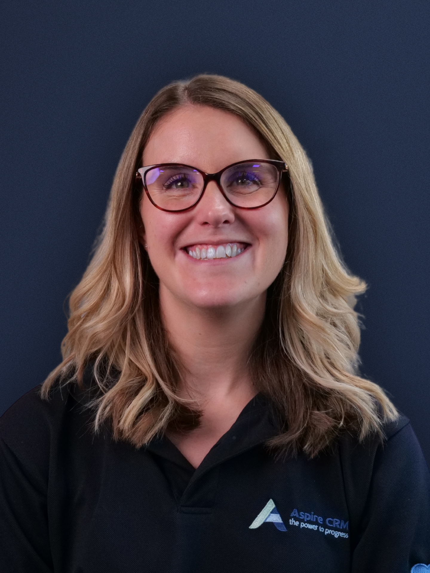 Aspire CRM employee headshot in branded clothing Aspire CRM employee headshot in branded clothing